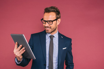 Handsome businessman working in a tablet