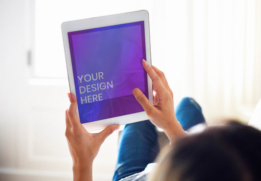 Woman Using Tablet on a Couch Mockup