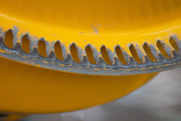 Closeup of bright yellow concrete mixer