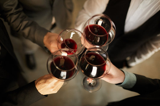 Top View Closeup Of People In Formalwear Clinking Wine Glasses During Event, Copy Space