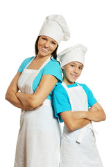 Smiling female chef with assistant on white background