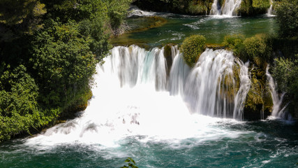 Close view to the waterfall in the mountain lake in the national park of Croatia in summer