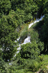 Fototapeta na wymiar Diagonal view on waterfall in the mountain lake in the national park of Croatia
