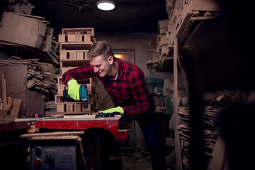 Male worker working with drill