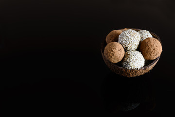 Energy balls of date fruitss and nuts. Raw dessert on a dark background.