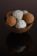 Energy balls of date fruitss and nuts. Raw dessert on a dark background.