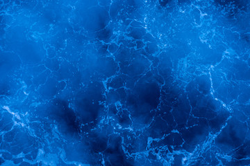 Dark blue deep sea surface, water with sea foam on a stormy day