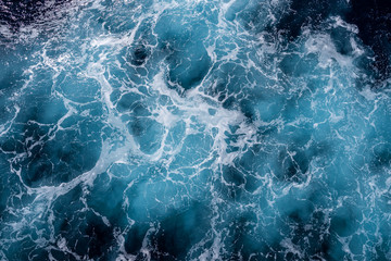 Fototapeta na wymiar Rough deep turquoise and blue Mediterranean sea with white foam texture background