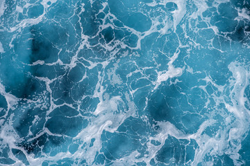 Rough deep turquoise and blue Mediterranean sea with white foam texture background