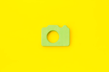 Blogger concept with photo camera on yellow background top view mockup