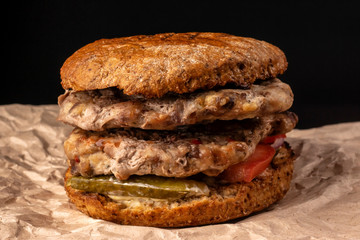 Powerful juicy burger with two chops and vegetables