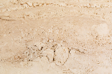 Closeup of beige porous stone textured wall. Neutral beige nature background for design and skins.