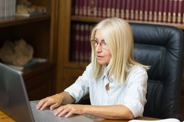 Mature businesswoman using her laptop