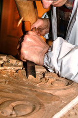 Craftsman carves wood