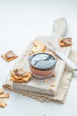 Liver pate with crisps on a white background. Copy space.