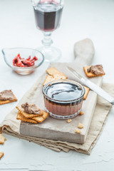 Liver pate with crisps on a white background. Selective focus.