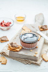 Liver pate with crisps on a white background. Copy space.