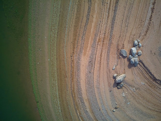 Aerial view of the Valdecañas reservoir, with green water from the algae and natural lines of the...