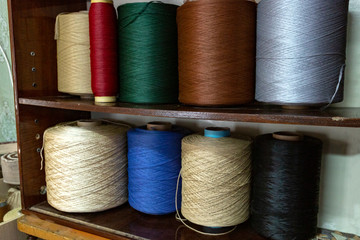 huge spools of colorful thread in a shelf