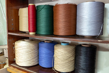 huge spools of colorful thread in a shelf