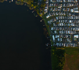 aerial-view of a neighborhood and lake in the summer