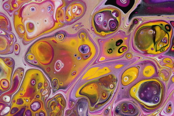 closeup on a retro abstract acrylic pour painting that is done in golden yellow, black, magenta, white, and dark violet.