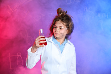 Emotional pupil holding conical flask in smoke against blackboard with chemistry formulas
