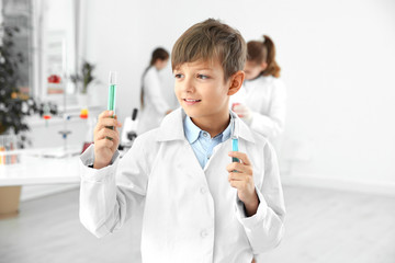 Smart pupil with test tubes at chemistry class