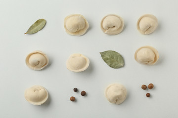 Composition with dumplings, bay leaves and pepper on white background, top view