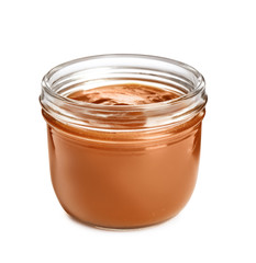 Jar of tasty caramel sauce isolated on white