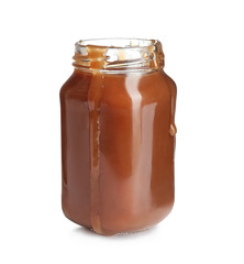 Jar of tasty caramel sauce isolated on white