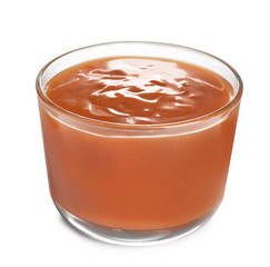 Glass of tasty caramel sauce isolated on white