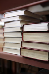 Stacks of books on shelf in library