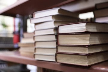 Stacks of books on shelf in library