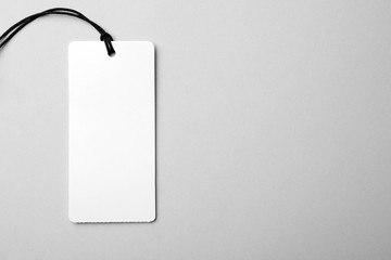Cardboard tag with space for text on light background, top view