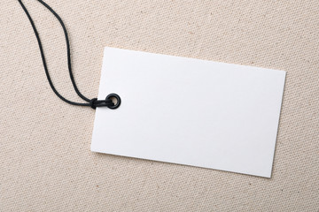 Cardboard tag with space for text on color fabric, top view