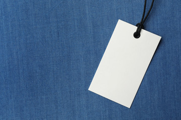 Cardboard tag with space for text on color fabric, top view