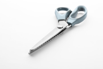 Pair of sewing scissors on white background
