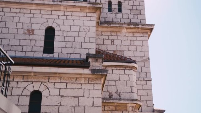 Beautiful Old Steeple Architecture At Pakostane, Croatia. Tilt up to sun rays beaming from behind old clock tower.