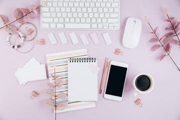 Flat lay, top view office table desk frame. Feminine desk workspace with succulent, laptop, glasses, diary and golden clips on violet background