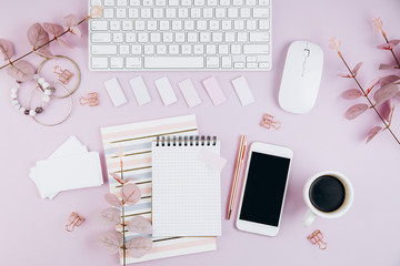 Flat lay, top view office table desk frame. Feminine desk workspace with succulent, laptop, glasses, diary and golden clips on violet background
