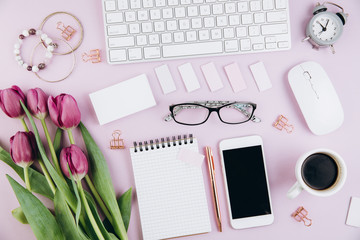 Flat lay, top view office table desk frame. Feminine desk workspace with succulent, laptop, glasses, diary and golden clips on violet background