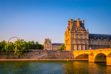 Sunset view on bridge and buildings on the Seine river in Paris, France