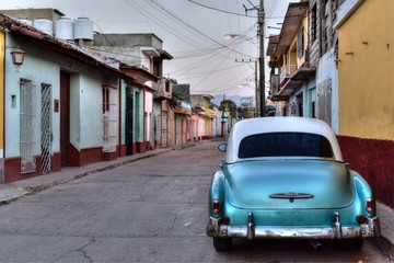 Old blue american car parked in the street of Trinidad, Cuba