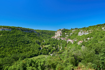 Landscape view of the Dordogne tributary river valley with the medieval french village of Rocamadour built on the cliff, Lot Department, Quercy, Occitanie Region, France. UNESCO world heritage site.
