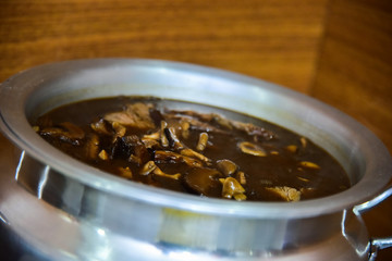 bowl of  meat and mushroom