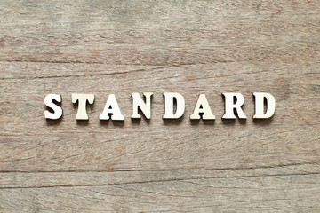 Letter block in word standard on wood background