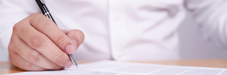 Wide View of Businessman Signing Contract