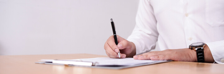 Wide View of Businessman Signing Contract