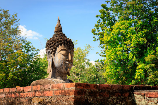 Buddha head stucco at the ruins in Sukhothai historical park in Thailand, Buddha statue, Old Town,Tourism, World Heritage Site, Civilization,UNESCO.